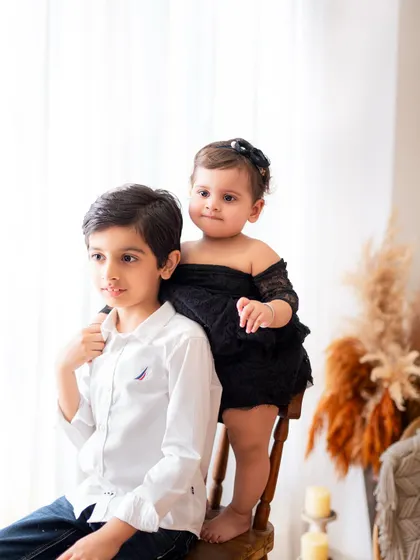 A quiet moment between brother and sister. This photo highlights the gentle and protective nature of an older sibling, creating a timeless memory.