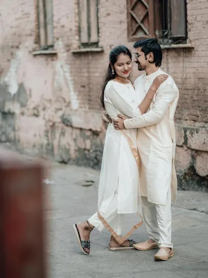 A sweet and playful pose in a city alley. Her leg pop adds a touch of fun and romance to the embrace.