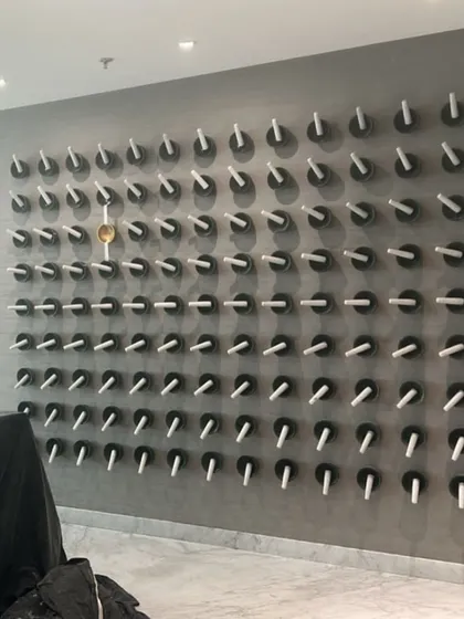 This unique wall installation at Hamdard Laboratories adds a tactile and artistic element to the workspace. The repetitive forms create a visually interesting texture that enhances the overall design narrative of craftsmanship and detail.