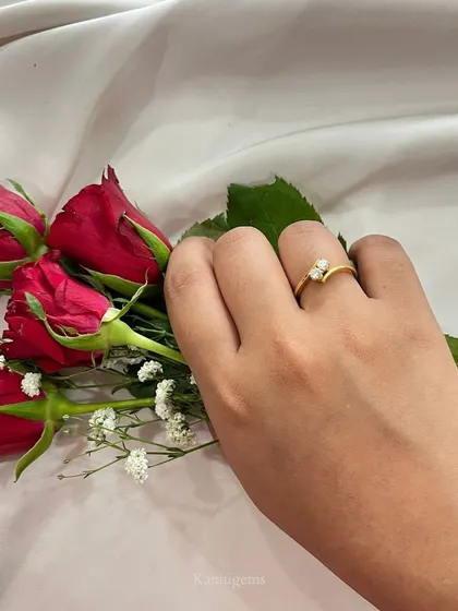 Two hearts, one sentiment. This delicate gold ring with two pear-shaped diamonds coming together is a simple yet profound symbol of a love that lasts forever.