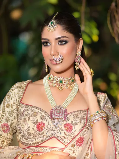 Another beautiful portrait, this time against a natural green background. The soft lighting highlights the radiant quality of her skin and the intricate details of her outfit.