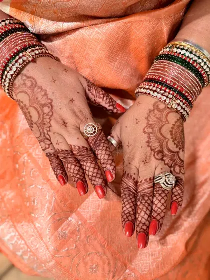 A full view of the hands, showcasing the deep and even stain of the Karwachauth mehndi.