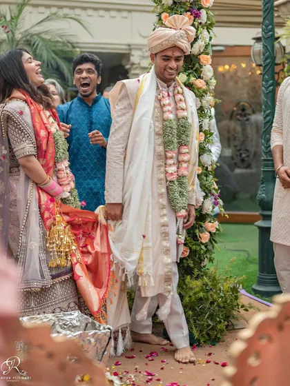 The couple enjoying the wedding rituals, surrounded by the happy faces of their closest family and friends.