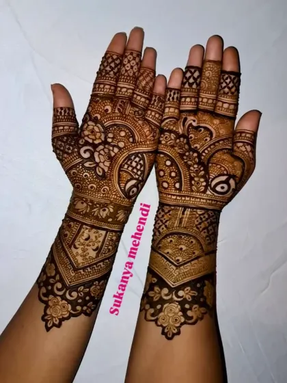 A beautiful example of a full-hand engagement mehendi. The design is a mix of Arabic and Indian styles, with bold outlines and delicate filler patterns creating a balanced and elegant look.