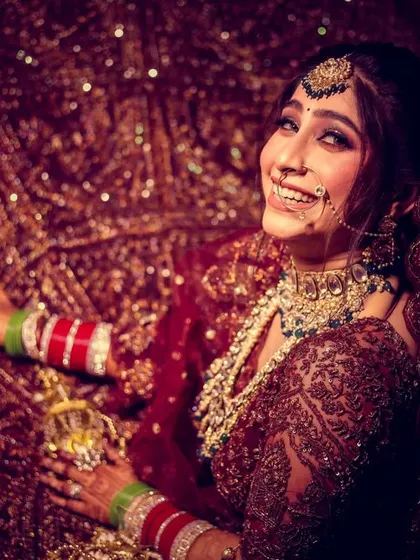 A joyful bridal portrait, with the bride's happy smile lighting up the frame.