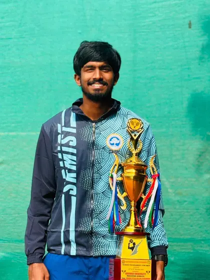 Another shot of Oges in his university team jacket with the South Zone championship trophy.
