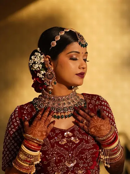 Our goal is to make a bride look like herself, just more defined and finished. This look achieves that with a soft, natural base, glamorous eyes, and a bold lip, a classic combination for a velvet lehenga.