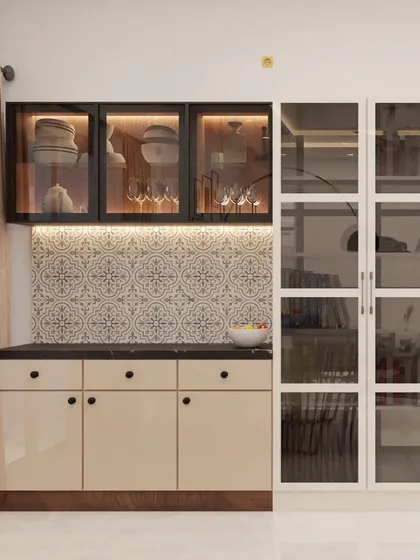 A different style of crockery unit, this one combines beige lacquered cabinets with black-framed glass uppers and a patterned tile backsplash. The adjacent tall glass cabinet is perfect for displaying books or decor.