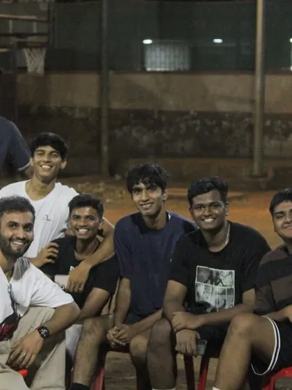 A group of young players hanging out on the sidelines, supporting their friends and enjoying the tournament atmosphere.