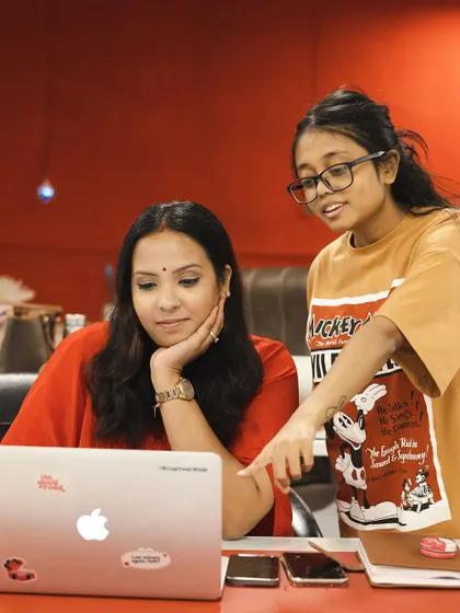 A candid moment of discussion and collaboration between our team members. We believe in mentorship and learning from each other.