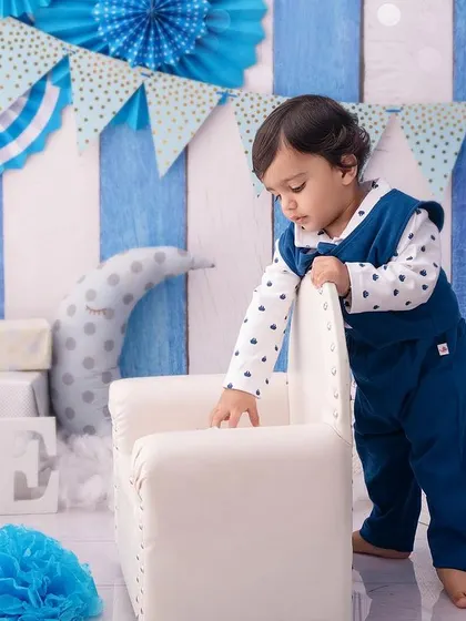 This little gentleman is exploring his birthday setup, a candid moment of a toddler on the move.