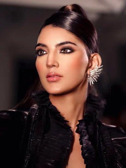 A high-fashion beauty shot with a sleek ponytail and a dramatic ear cuff, showcasing a powerful and contemporary look.