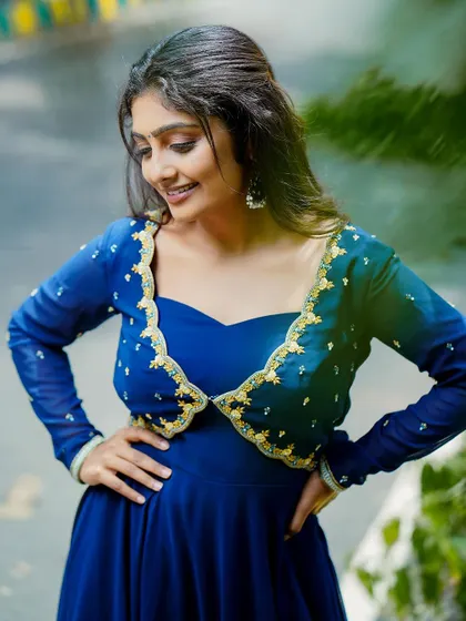 An outdoor shot of a model in a royal blue gown, using natural light for a soft, pleasing effect.
