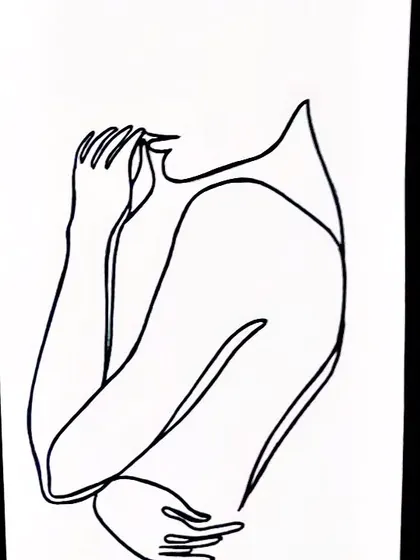 A faceless figure drawn with a single line, conveying emotion through posture alone. This abstract line art is a great example of how minimalism can be deeply expressive.