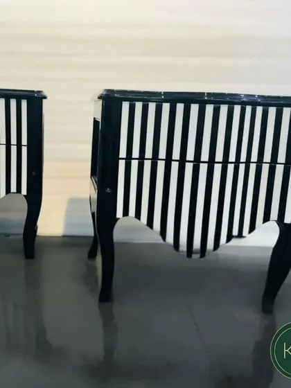 A pair of bold side cabinets with a black and white striped finish and cabriole legs. This is an example of our ability to create high-impact, custom-finished furniture.