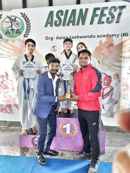 A moment of celebration on the podium at the Asian Fest, as our team receives a trophy.