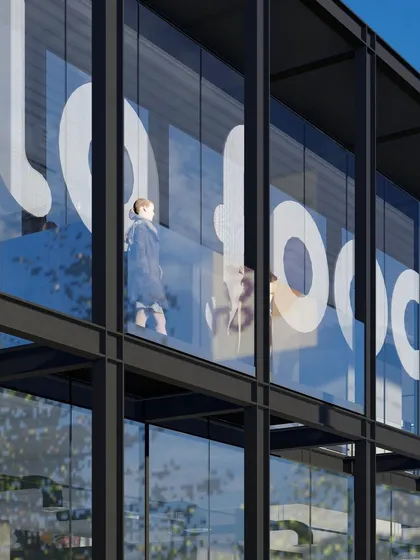 A sleek marketing and experience center for a leading food company. The design uses a steel eco-skeleton and a glass skin, with large graphics that are integrated into the facade, creating a building that is both a billboard and a humble backdrop.
