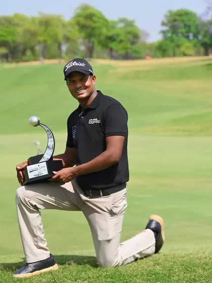 Golfer M. Dharma proudly holding his trophy after winning the Gurgaon Open. We provide specialized sports performance training to help golfers like him achieve their peak.