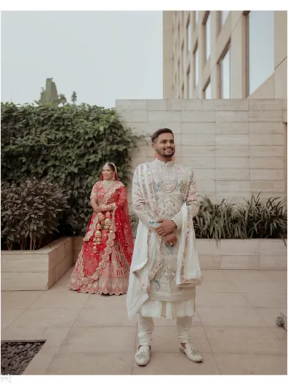 A creative composition with the groom in the foreground and the bride beautifully positioned in the background.