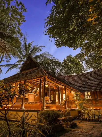 A tranquil evening view of one of our heritage cottages. The warm lighting and traditional wooden architecture create a peaceful and secure atmosphere for rest and rejuvenation after a day of therapy.