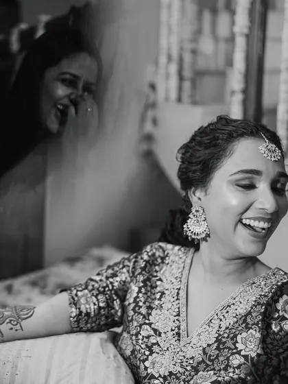 A joyful, candid moment between the bride and one of her stylists, a testament to the trust and friendship built during the virtual curation process.
