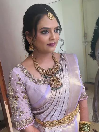 A portrait showing the elegant hairstyle and the antique gold jewelry.