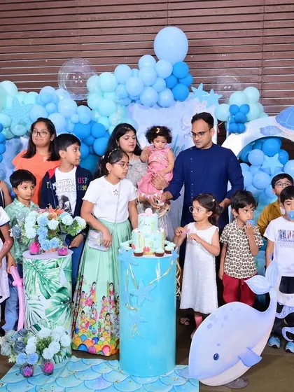 A beautiful group photo of all the children celebrating with the birthday girl at her 'One-der the Sea' party.