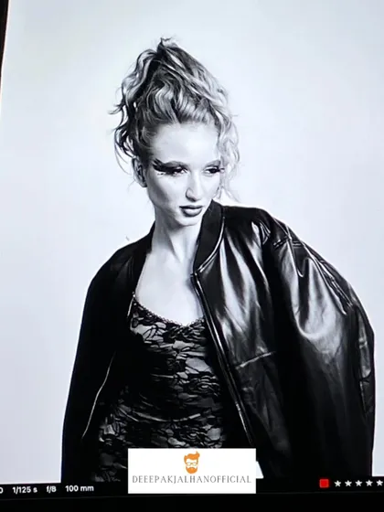 A black and white shot from the HBS Magazine 2025 photoshoot. The high-fashion ponytail, dramatic eye makeup, and leather jacket combine to create a bold and powerful editorial image.