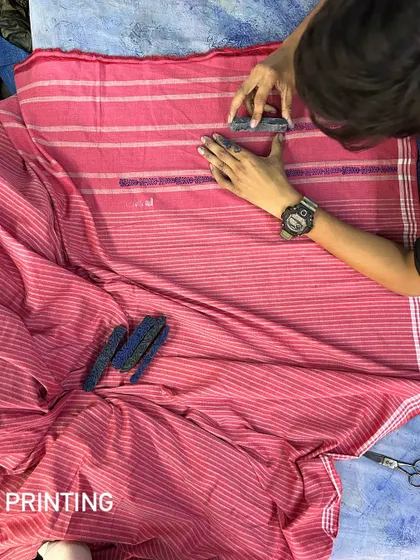 The first step in creating our Chikankari sarees is printing the design onto the handwoven fabric. This guide ensures that the subsequent embroidery is precise and beautiful.