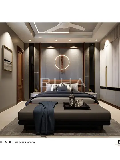 For this guest bedroom in Greater Noida, we created a welcoming and refined space. The design features a leatherette headboard and a distinctive circular light fixture, complemented by a full wall of wardrobes with elegant metallic handles, ensuring ample storage for visitors.