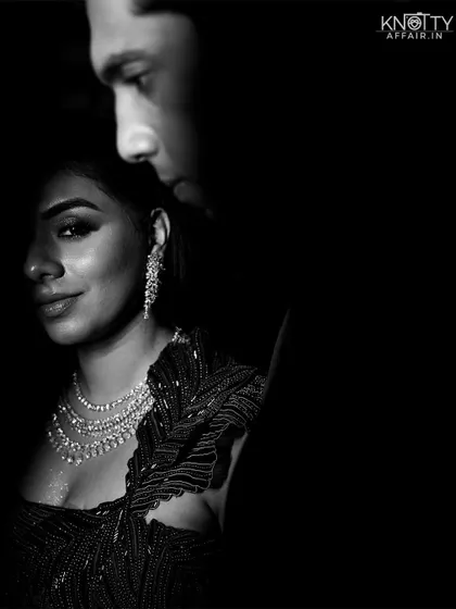 A stunning black and white close-up portrait using shadow and light to sculpt the couple's features and create a sense of intimacy.