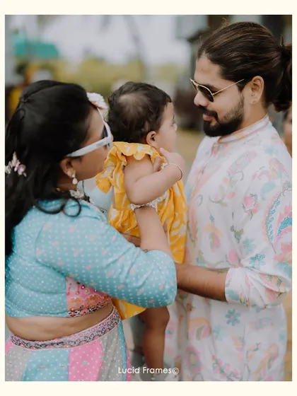 A sweet family moment with the couple and their young child during the celebration.