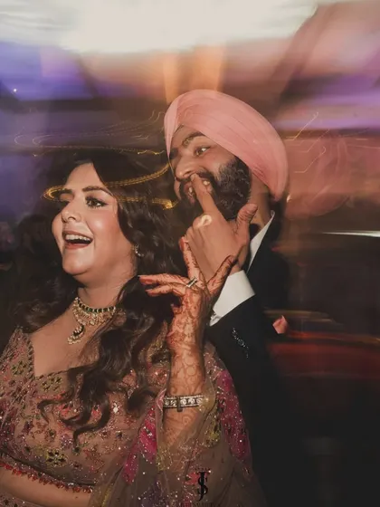 A fun, candid shot from the Sangeet night. Their coordinated outfits look fantastic even in motion, proving that style and comfort can go hand in hand.