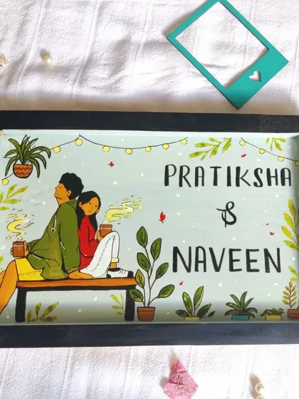 A personalized nameplate featuring a custom illustration of the couple. We love creating these unique pieces that capture a bit of our clients' personality and story.