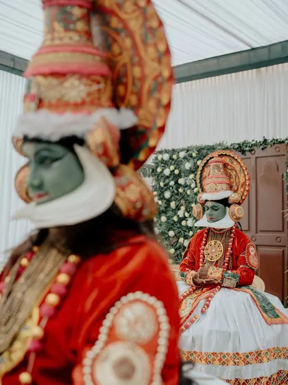 A detail shot focusing on the incredible artistry of the Kathakali performers. This adds a rich, cultural layer to the wedding story, highlighting the unique entertainment at the event.