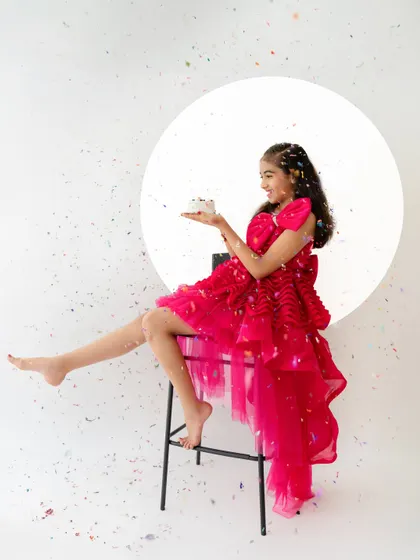 A playful and dynamic shot with confetti falling around the birthday girl. These action shots add a sense of fun and celebration to the gallery.