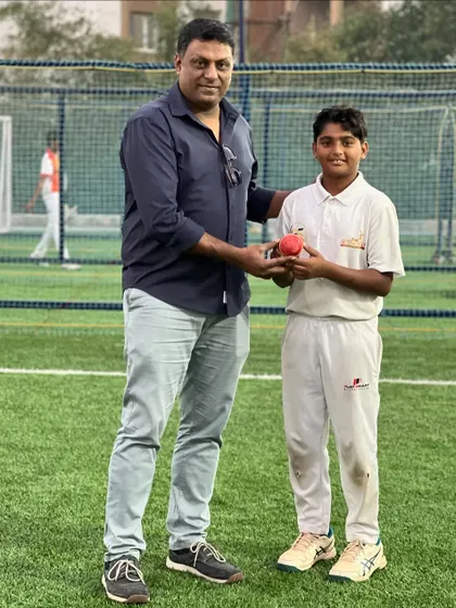 A player receives a game ball from a mentor, a symbolic gesture recognizing a special performance or milestone.