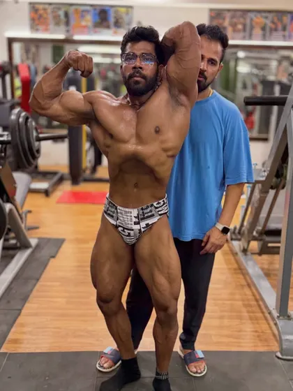 Classic pose check. Even during carb-loading, we practice our posing to ensure every detail is perfect on stage.