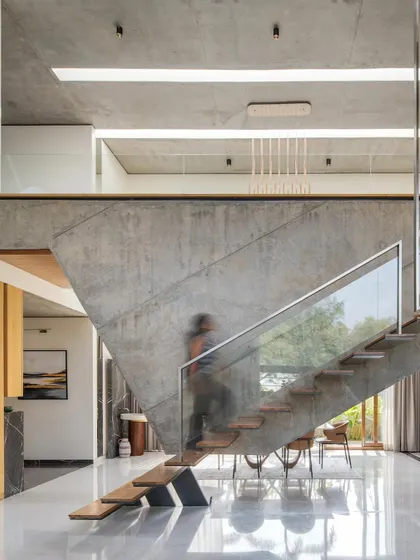 A motion-blurred view of the floating staircase at The Quarry House, emphasizing its role as a dynamic and central feature of the home.