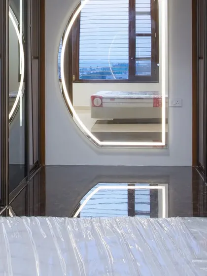 A creative perspective showing the reflection of the bedroom in the wardrobe's geometric mirror panels. This highlights how I use reflective surfaces to create a sense of depth and light in a room.
