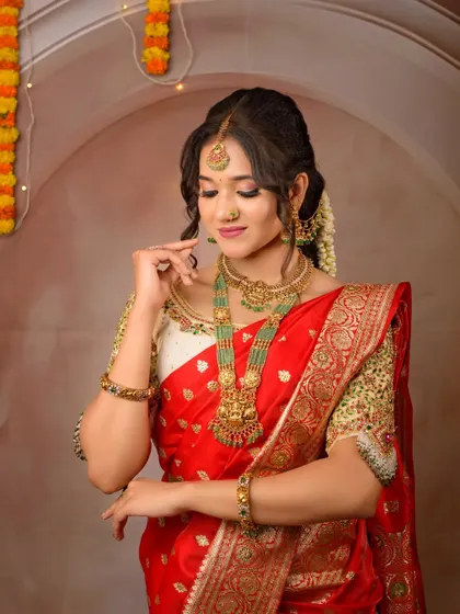 A closer look at the beautiful temple jewelry paired with my red silk rental saree. The heavily embroidered blouse adds to the richness of the overall look.