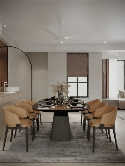 This dining area is all about modern sophistication. The design features an elegant oval dining table with plush upholstered chairs, set against a backdrop of clean lines and a subtle, arched partition.