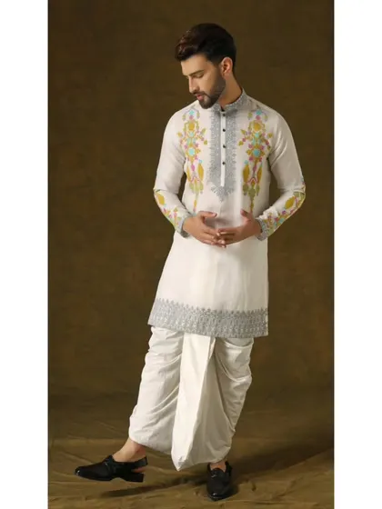 The Narayan Nirvana dhoti set. This ivory organza kurta is meticulously crafted with silver embroidery and vibrant pops of color, paired with a classic dhoti for timeless elegance.