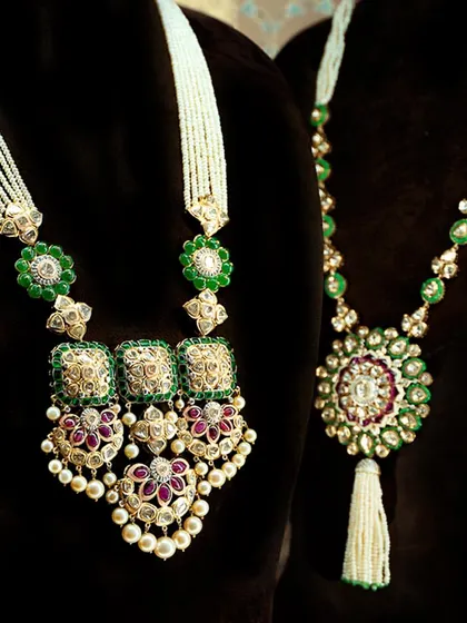 For the woman who dares to be different yet stays rooted in tradition. These Polki masterpieces, with their uncut diamonds, lush green beads, and ruby accents, tell a story of heritage and grandeur.