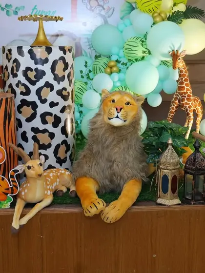 A detailed shot of the animal props and themed cake stands for Caleb's first birthday party.