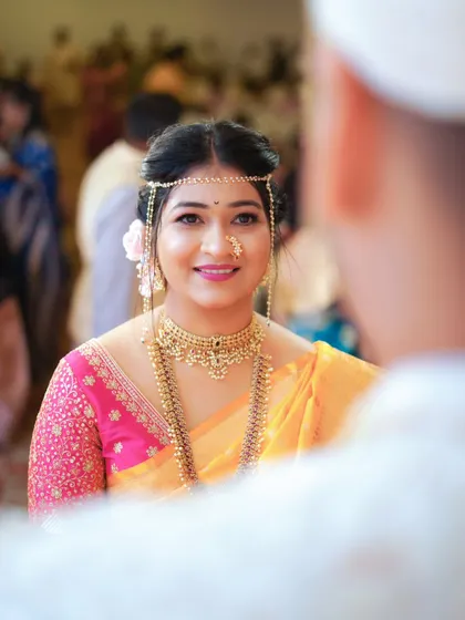 The bride's beautiful smile as she looks at her groom during the ceremony. This over the shoulder shot creates an intimate and personal feel.