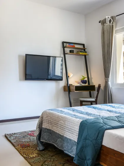 This bedroom features a compact, ladder-style desk, creating a functional workspace without taking up too much floor space. It's a perfect solution for adding a study nook to a guest room or smaller bedroom.