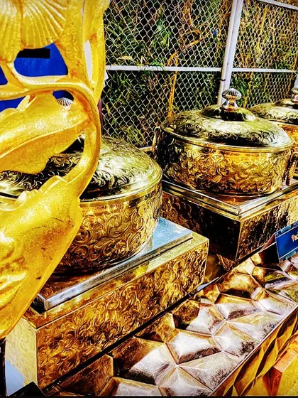 A detailed look at the ornate, textured golden buffet ware I use. The masquerade-style decor piece adds a unique and artistic flair to the overall presentation.