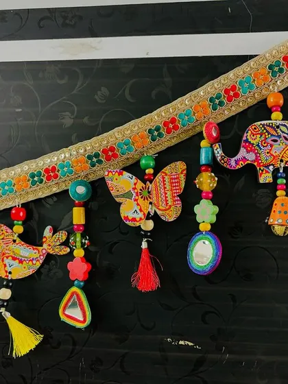 A detailed close-up of the 'Bageecha' Toran. You can see the intricate prints on the elephant and the tiny birds perched on the bead strings.