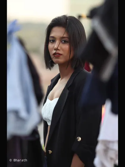A candid-style shot using foreground elements to create a sense of looking in on a private moment. This adds an intriguing layer to the portrait.